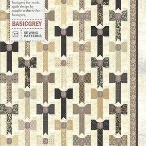 May include: A quilt pattern featuring a repeating bow tie design in various shades of gray, beige, and black. The quilt has a cream-colored background and a decorative border. The text "TIED & TRUE" and "BASICGREY" are visible.