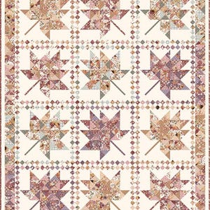 May include: A patchwork quilt featuring large maple leaf designs in shades of pink, beige, and brown. The leaves are composed of various patterned fabrics, set against a cream background. The quilt is bordered with a coordinating floral pattern.