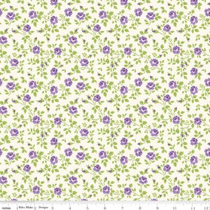 May include: Floral fabric with a repeating pattern of purple roses and green leaves on a cream background. The fabric is measured in inches, with a ruler along the bottom edge. The text "Riley Blake Designs" is visible.