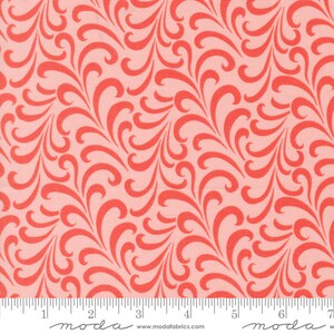 May include: Pink fabric with a repeating pattern of coral red stylized swirls. The fabric is measured with a ruler in inches.