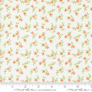 May include: White fabric with a small, repeating pattern of orange flowers and green leaves.