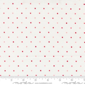 May include: White fabric with a repeating pattern of red and light pink polka dots. The dots are evenly spaced across the surface. The fabric has a ruler printed along the bottom edge.