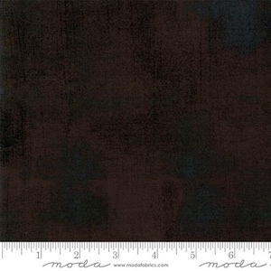 May include: A dark brown fabric with a subtle textured pattern. The fabric has a slightly distressed look, with a hint of blue and gray in the background.