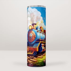 Pode incluir: Um comboio a vapor azul e dourado com fumo branco a sair da chaminé, a viajar numa linha férrea com relva verde e um céu azul com nuvens brancas no fundo.