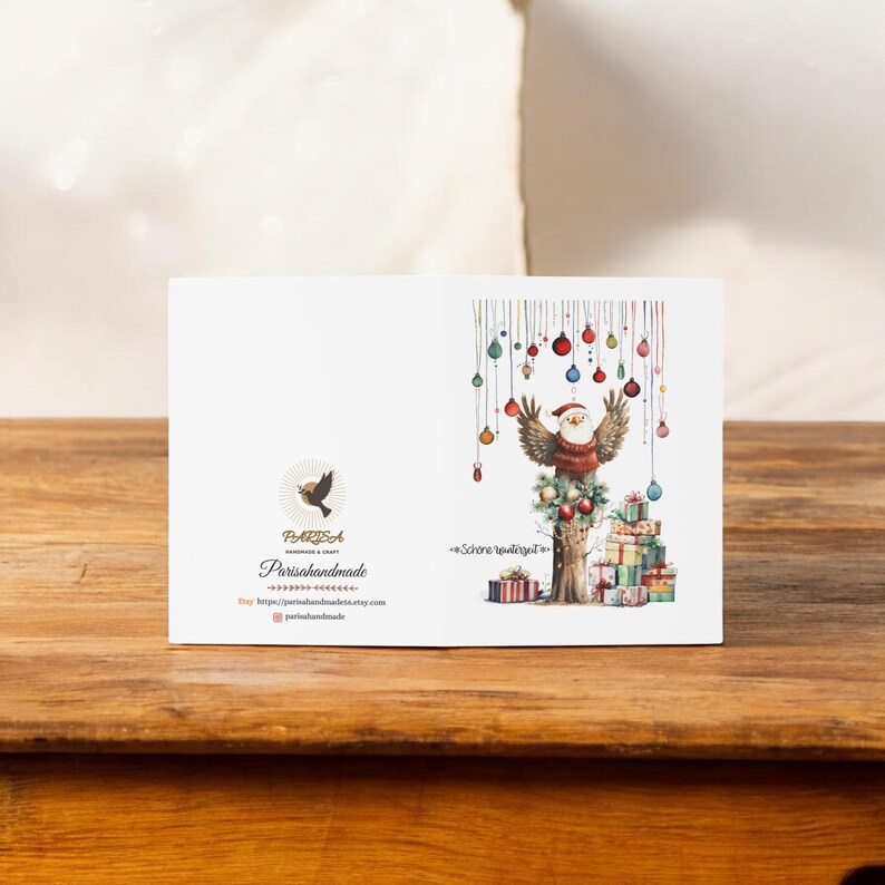 May include: A Christmas card featuring a cartoon bird wearing a Santa hat and holding a Christmas tree ornament. The bird is perched on a tree trunk with presents stacked underneath. The card has a white background with colorful Christmas ornaments hanging from the top. The text "Sch&ouml;ne Weihnachten" is written on the card.