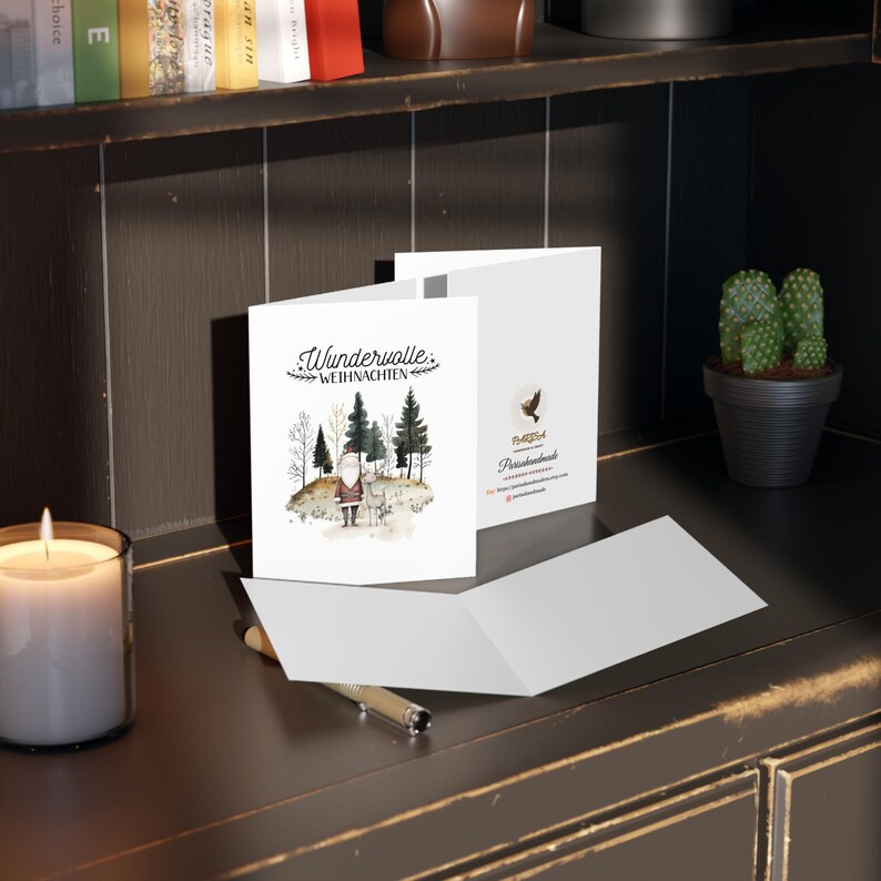 May include: A white card with a watercolor illustration of a Santa Claus figure in a forest setting. The text "Wundervolle Weihnachten" is written in black script on the front of the card.