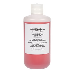 May include: A clear plastic bottle containing a red liquid. The label reads "K22-1/Co5g/Lt High Thickness Gold Plating Solution 1 Litre". It also provides instructions for use, including the temperature and voltage required for plating.