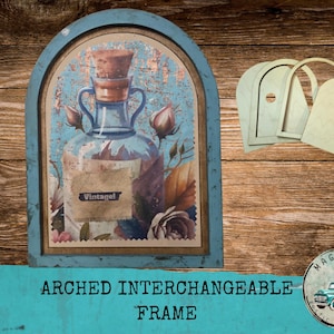 May include: An arched interchangeable frame with a vintage-style illustration of a glass bottle with a cork stopper, roses, and the word "Vintagel". The frame is blue with a distressed finish. Additional wooden cutouts are included.