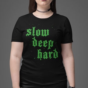 May include: Black t-shirt with a green graphic print that says "slow deep hard".