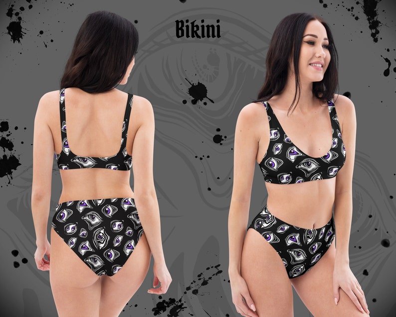 May include: Black bikini set with a repeating eye pattern in white and purple. The top is a scoop-neck style with thin straps, and the high-waisted bottoms feature the same eye design. The word "Bikini" is printed at the top.