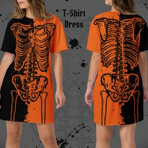 May include: Orange and black T-shirt dress with a skeleton graphic print. The dress has short sleeves and a relaxed fit.