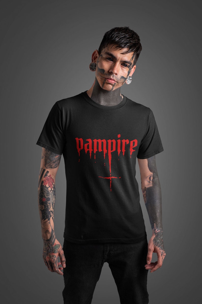 May include: Black t-shirt with a red "vampire" graphic with dripping blood and a cross underneath.