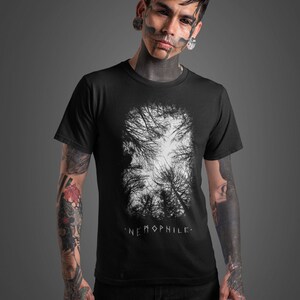 May include: A black t-shirt with a white graphic of a forest scene. The text "NEMOPHILE." is printed below the graphic.