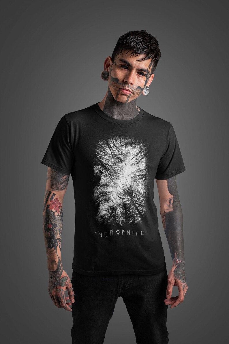 May include: A black t-shirt with a white graphic of a forest scene. The text "NEMOPHILE." is printed below the graphic.