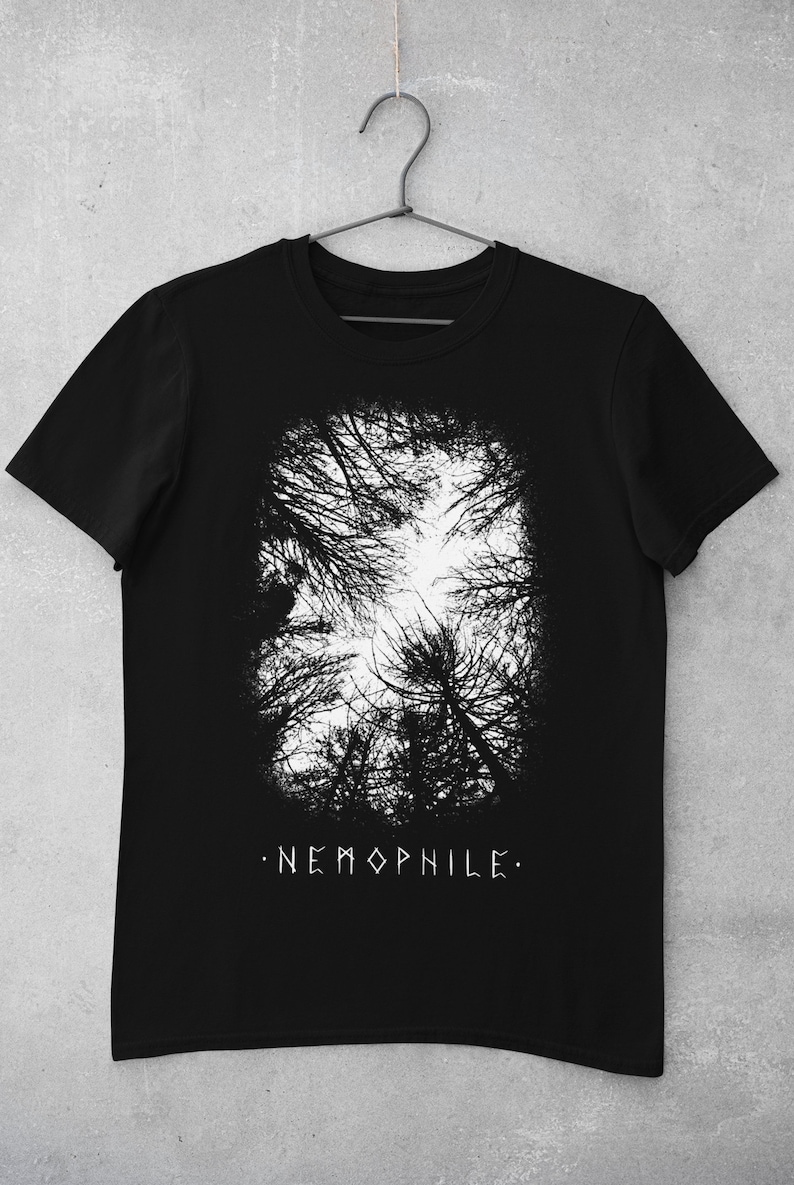 May include: Black t-shirt with a white graphic of a forest canopy and the text ".NEMOPHILE."