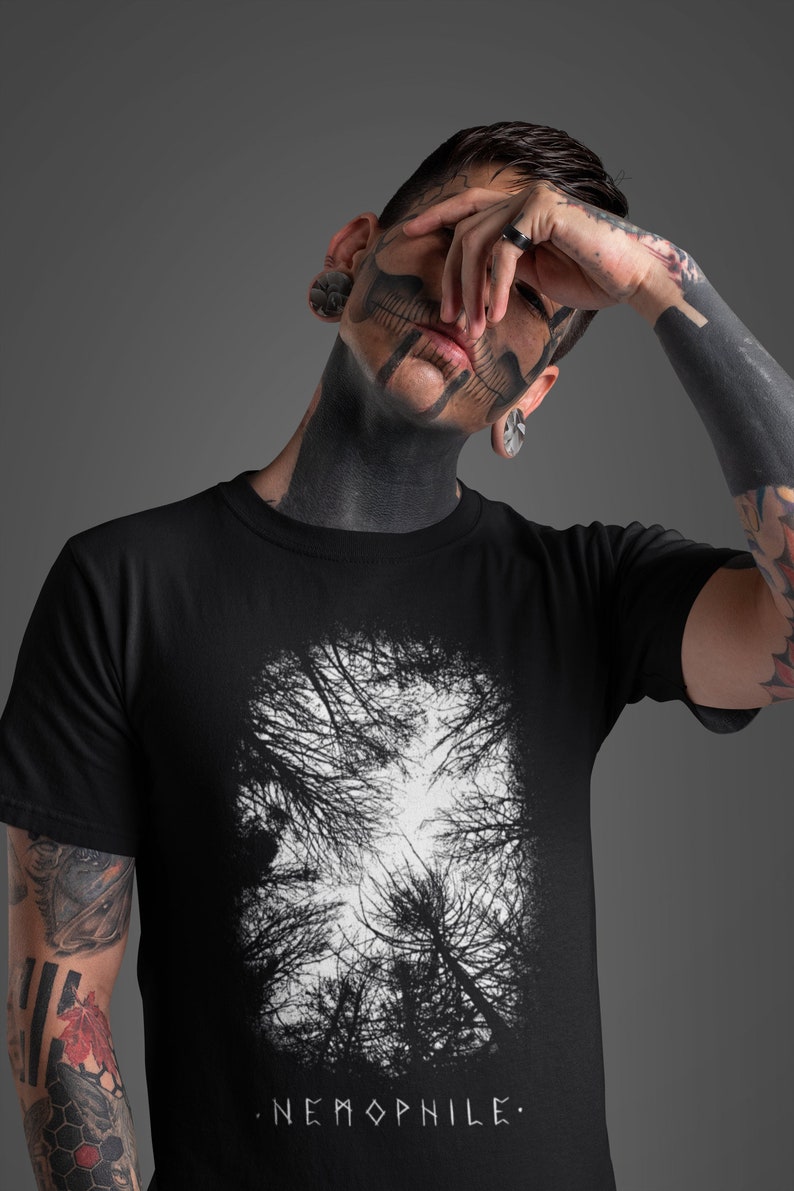 May include: Black t-shirt with a white graphic print of a forest scene. The text "NEMOPHILE." is printed below the graphic.