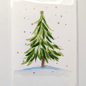 Carte de voeux simple sapin de Noël vert avec flocons d'or et d'argent, aquarelle peinte à la main, intérieur vierge, vendeur canadien
