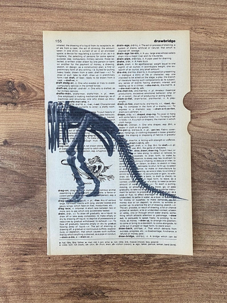 May include: A vintage dictionary page with a black dinosaur skeleton illustration and the word "dragon" below. The page is torn on the right side, and the text is visible.