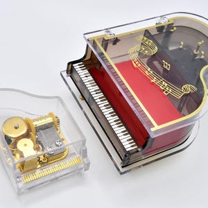 Dos pianos musicales antiguos: 1 joyero con cascabeles y 1 piano pequeño