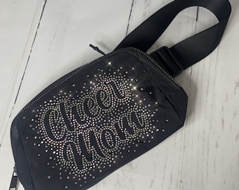 May include: Black fanny pack with a rhinestone design that says "Grace &  Thrill" in a cursive font.