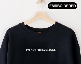 May include: Black sweatshirt with the text "I'm not for everyone" embroidered in white on the front.