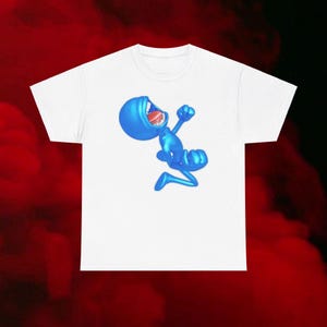May include: A white t-shirt with a blue cartoon character on it. The character is jumping and has its mouth open in a scream.