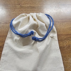 May include: A white cotton drawstring bag with blue cotton drawstrings.