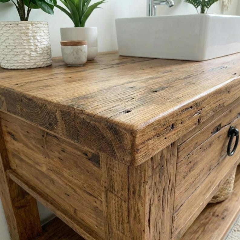 A rustic wooden bathroom vanity featuring two drawers with dark metal ring pulls, and an open bottom shelf for storage. The vanity is made of reclaimed wood with a natural finish.
Rustic Bathroom Vanity,  Wood Bathroom Vanity, Custom Single Sink Vanity, Unique Reclaimed Farmhouse Vanity with Storage