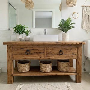A rustic wooden bathroom vanity featuring two drawers with dark metal ring pulls, and an open bottom shelf for storage. The vanity is made of reclaimed wood with a natural finish.
Rustic Bathroom Vanity,  Wood Bathroom Vanity, Custom Single Sink Vanity, Unique Reclaimed Farmhouse Vanity with Storage