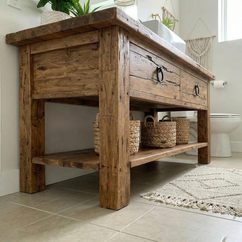 A rustic wooden bathroom vanity featuring two drawers with dark metal ring pulls, and an open bottom shelf for storage. The vanity is made of reclaimed wood with a natural finish.
Rustic Bathroom Vanity,  Wood Bathroom Vanity, Custom Single Sink Vanity, Unique Reclaimed Farmhouse Vanity with Storage