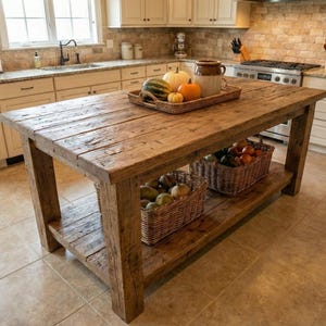 A rustic wooden kitchen island with a lower shelf and a distressed finish. Reclaimed Wood Kitchen Island , Farmhouse Rustic Kitchen Island with  Shelf, Counter Height Dining Table, butcher block island