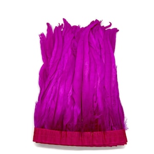 May include: A bunch of bright pink feathers trimmed with a pink ribbon.