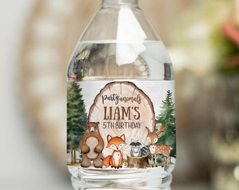 May include: A clear water bottle with a label featuring woodland animals. The label includes a bear, fox, raccoon, and deer, with the text "Party Animals Liam's 5th Birthday" on a wood slice background. The bottle has a white cap.