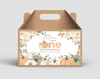May include: A brown cardboard box with a handle, decorated with a white label featuring a watercolor illustration of pumpkins, flowers, and greenery. The label reads "Our little pumpkin is turning one" and "Thank you so much for coming to Katherine's First Birthday".