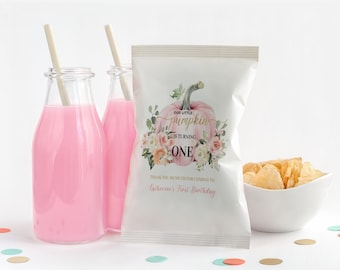 May include: A white favor bag with a pink and gold pumpkin design. The bag has the text "Our little pumpkin is turning one" and "Thank you so much for coming to Satherine's First Birthday".