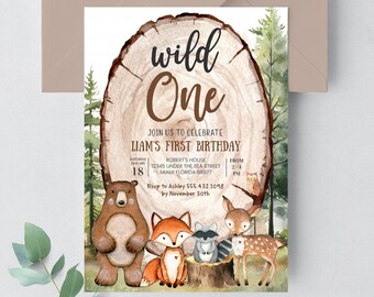 May include: A woodland-themed first birthday invitation with a brown bear, fox, raccoon, and deer standing on a tree stump. The invitation features the text "wild one" and details for the party, including the date, time, location, and RSVP information.
