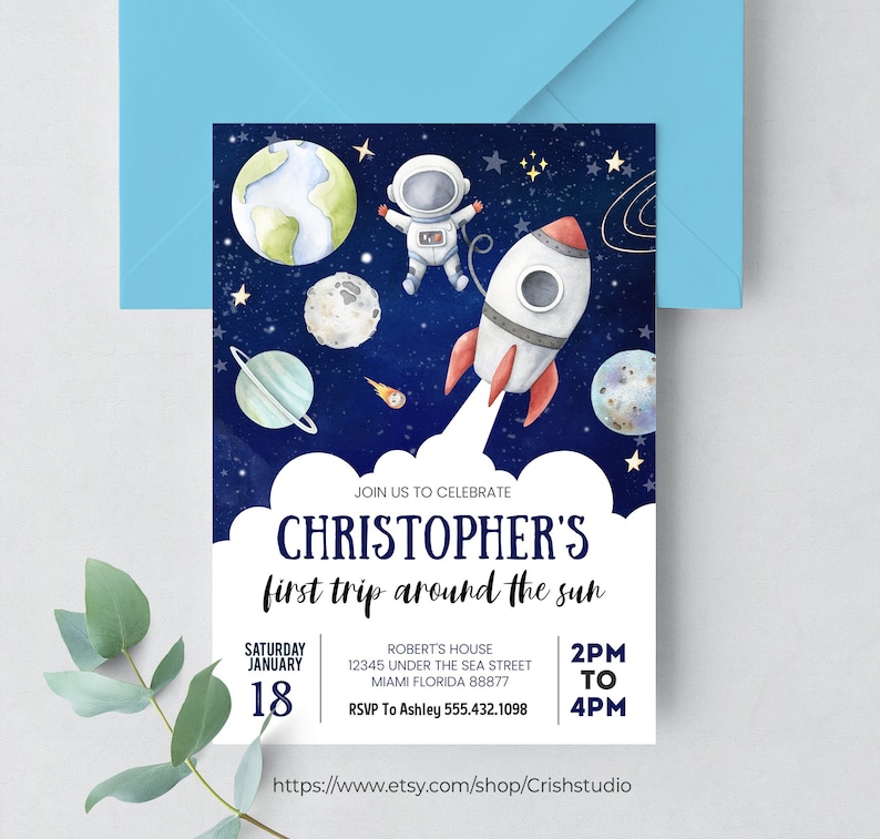 May include: A blue and white invitation with a cartoon astronaut in a rocket ship flying through space. The text reads "Join us to celebrate Christopher's first trip around the sun" with the date and time of the event.