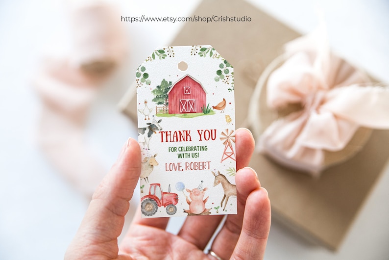 May include: A white thank you tag with a red barn, farm animals, and a tractor. The text reads "Thank you for celebrating with us! Love, Robert."