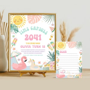 May include: A framed time capsule sign with the text "TIME CAPSULE 2041" and "OLIVIA TURN 18". The sign has a gold frame and is decorated with summer-themed illustrations. A matching card is next to the frame.