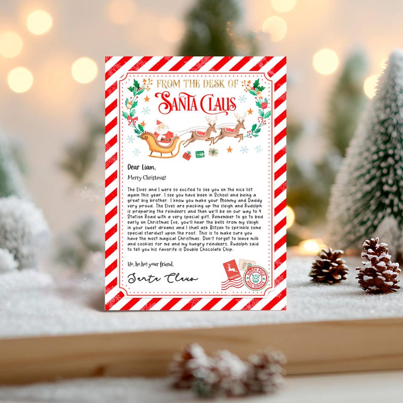 May include: A red and white striped card with a festive Christmas illustration of Santa Claus in a sleigh pulled by reindeer. The card features a handwritten letter from Santa Claus to Liam, wishing him a Merry Christmas and mentioning that he has been on the nice list. The letter also includes a reminder to leave milk and cookies for Santa and his reindeer.