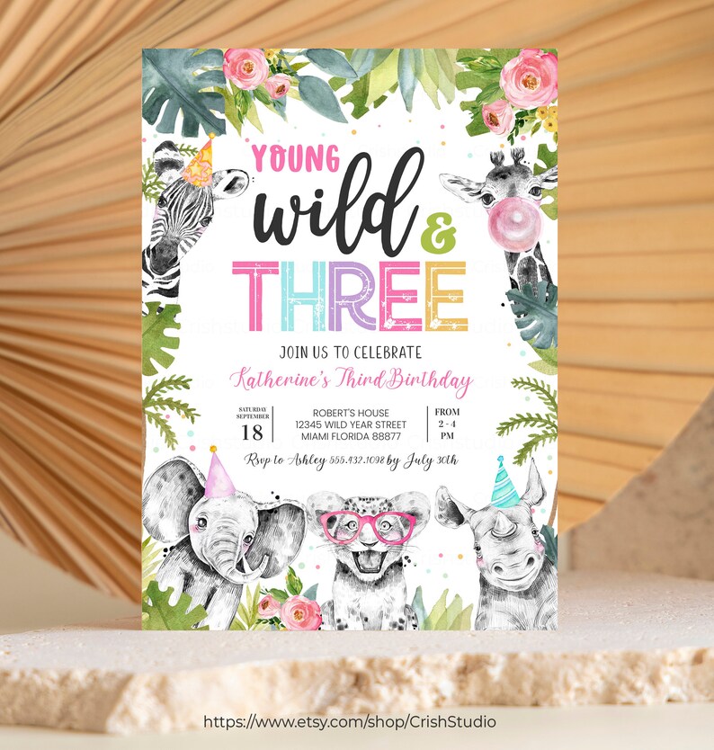 May include: A colorful birthday invitation with a jungle theme. The invitation features a zebra, giraffe, elephant, rhino, and leopard. The text reads "Young Wild & Three" and includes details for Katherine's third birthday party. RSVP to Ashley by July 30th.