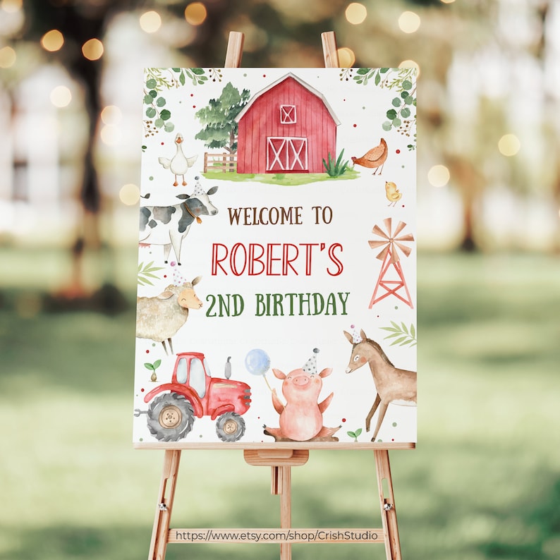 May include: A white welcome sign with a red barn, farm animals, and green foliage. The sign says "Welcome to Robert's 2nd Birthday".