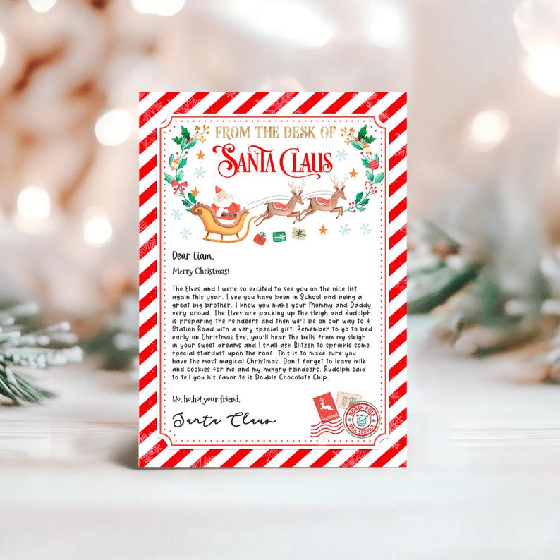 May include: A red and white striped letter from Santa Claus to Liam. The letter is decorated with a green wreath and a red bow. The letter says "From the desk of Santa Claus" and "Dear Liam, Merry Christmas!" The letter is addressed to 4 Station Road.