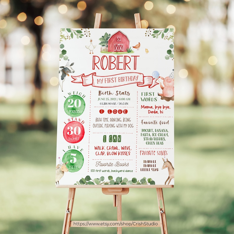 May include: A green, red, and white first birthday sign with a farm theme. The sign says "Robert My First Birthday" and includes details like weight, height, and favorite foods.