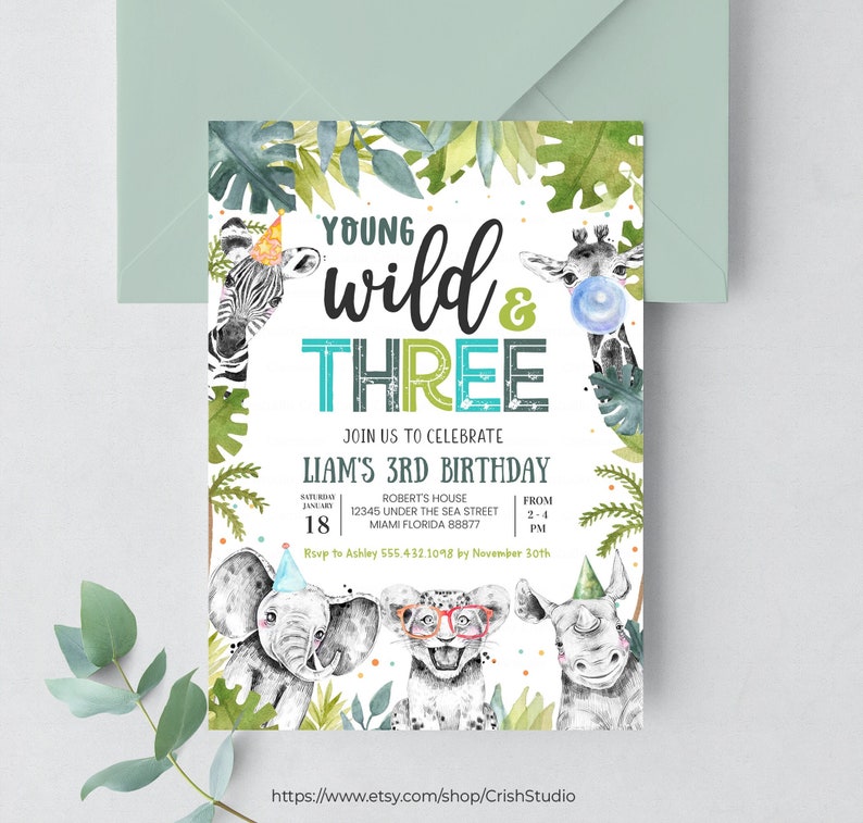 May include: A jungle-themed birthday invitation for a 3-year-old boy. The invitation features a watercolor illustration of a zebra, giraffe, elephant, lion, and rhinoceros wearing party hats. The text reads "Young Wild & Three" and includes details for the party, including the date, time, location, and RSVP information.