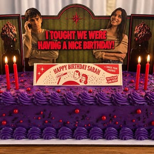 May include: A rectangular cake with purple frosting, red sprinkles, and six red candles. It features a decorative topper with two people, the text "I TOUGHT WE WERE HAVING A NICE BIRTHDAY!", and a "HAPPY BIRTHDAY SARAH" sign with additional text.