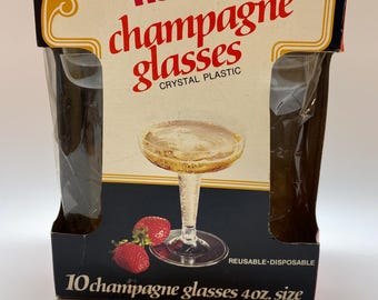 May include: A box of 10 Hefty champagne glasses made of crystal plastic. The glasses are 4 oz. in size and are reusable and disposable. The box is black with a gold border and features a picture of a champagne glass with strawberries.