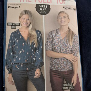 May include: Sewing pattern for "The Polly Top" by Sewgirl, featuring two women modeling the top. The pattern includes sizes 8-22 (US 6-20, EUR 36-50). The design includes a bound neckline finish and shirring elastic.