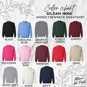 Gildan 18000 crewneck sweater color chart displaying black, carolina blue, graphite heather, forest green, garnet, heliconia, light pink, maroon, red, sand, sport grey, white, and navy