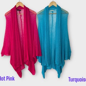 May include: Two open-front cardigans in hot pink and turquoise hang on wooden hangers. The cardigans are made of a lightweight, sheer fabric. The words "Hot Pink" and "Turquoise" are written in purple text below each cardigan.